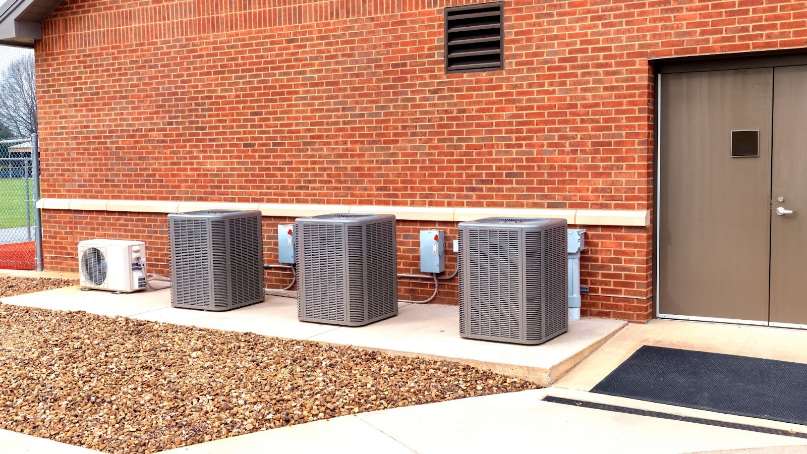 Three HVAC Units standing outside a building.
